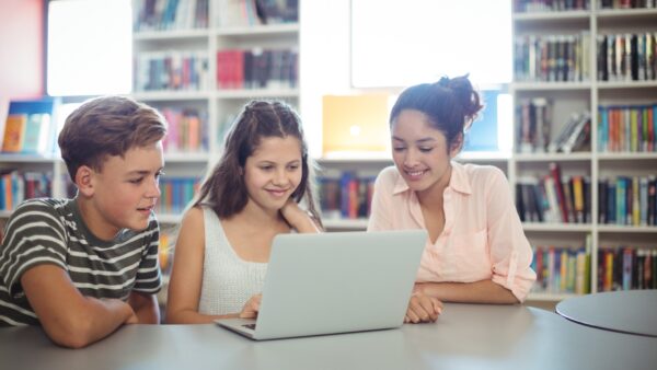 Three children using a laptop