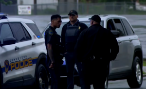 Senator Langerholc standing next to police officers